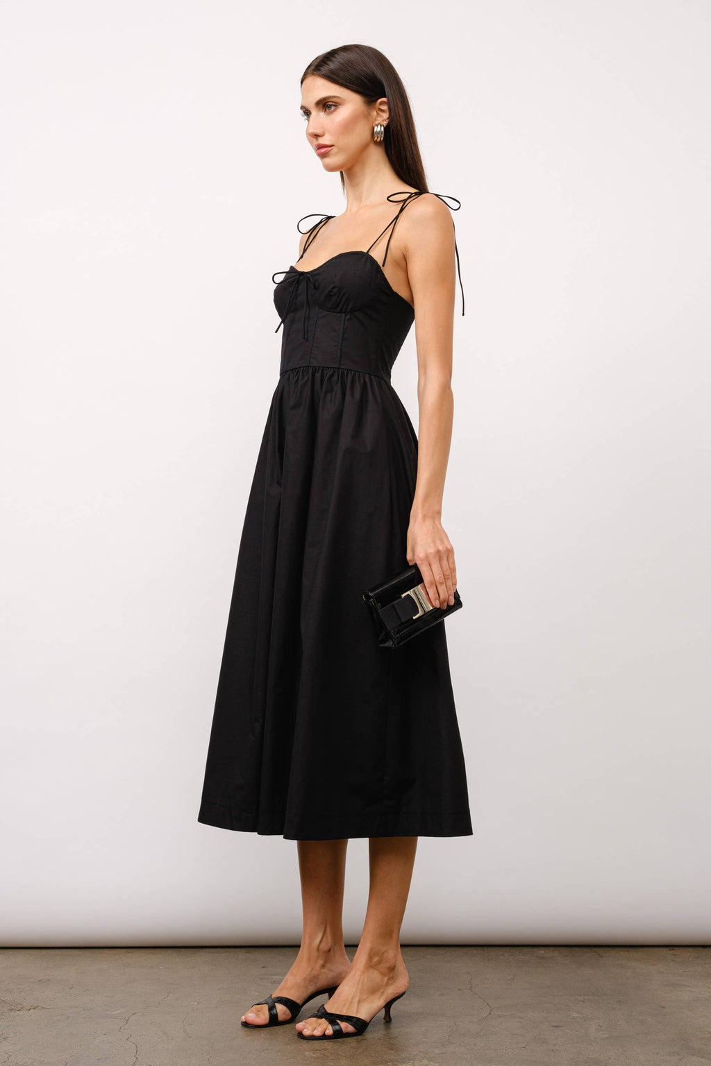 Black midi dress, corset midi dress, tie-strap dress, sweetheart neckline dress, black dress for date night, cocktail party dress, summer wedding outfit, corset dress with boning, elegant black dress, versatile midi dress, dress with pockets, fashion boutique dress.