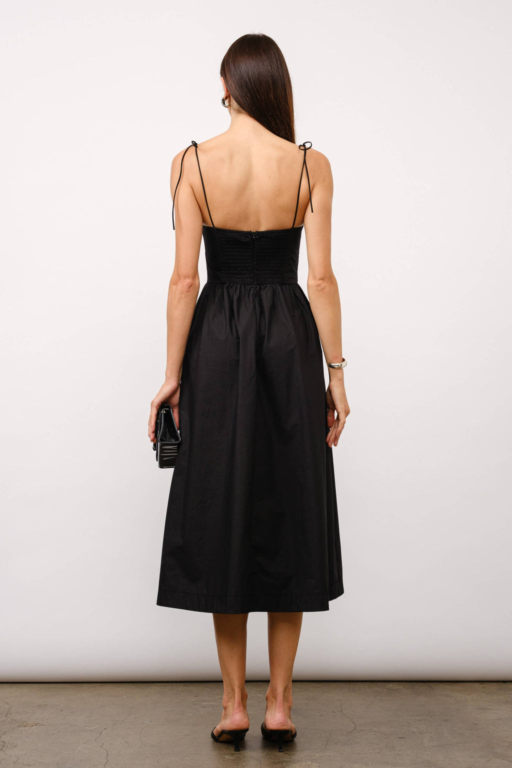Black midi dress, corset midi dress, tie-strap dress, sweetheart neckline dress, black dress for date night, cocktail party dress, summer wedding outfit, corset dress with boning, elegant black dress, versatile midi dress, dress with pockets, fashion boutique dress.