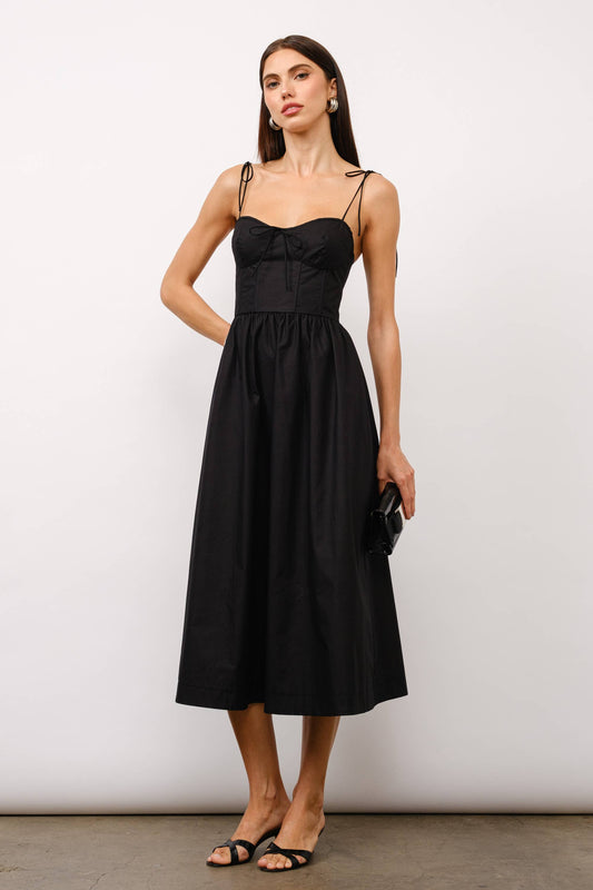 Black midi dress, corset midi dress, tie-strap dress, sweetheart neckline dress, black dress for date night, cocktail party dress, summer wedding outfit, corset dress with boning, elegant black dress, versatile midi dress, dress with pockets, fashion boutique dress.