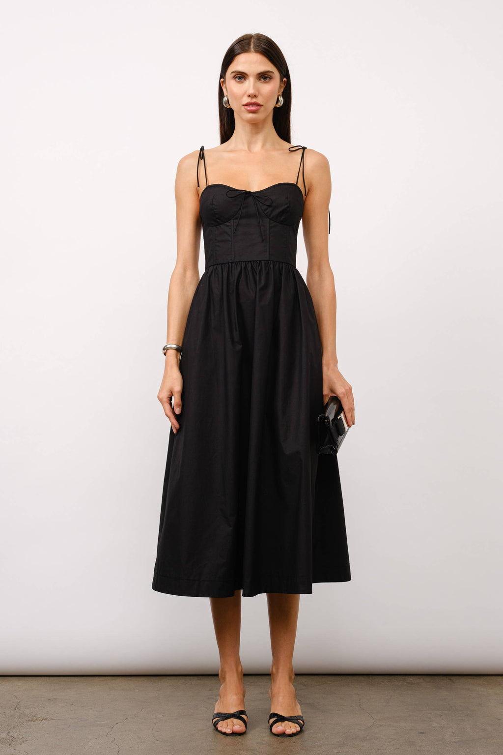 Black midi dress, corset midi dress, tie-strap dress, sweetheart neckline dress, black dress for date night, cocktail party dress, summer wedding outfit, corset dress with boning, elegant black dress, versatile midi dress, dress with pockets, fashion boutique dress.