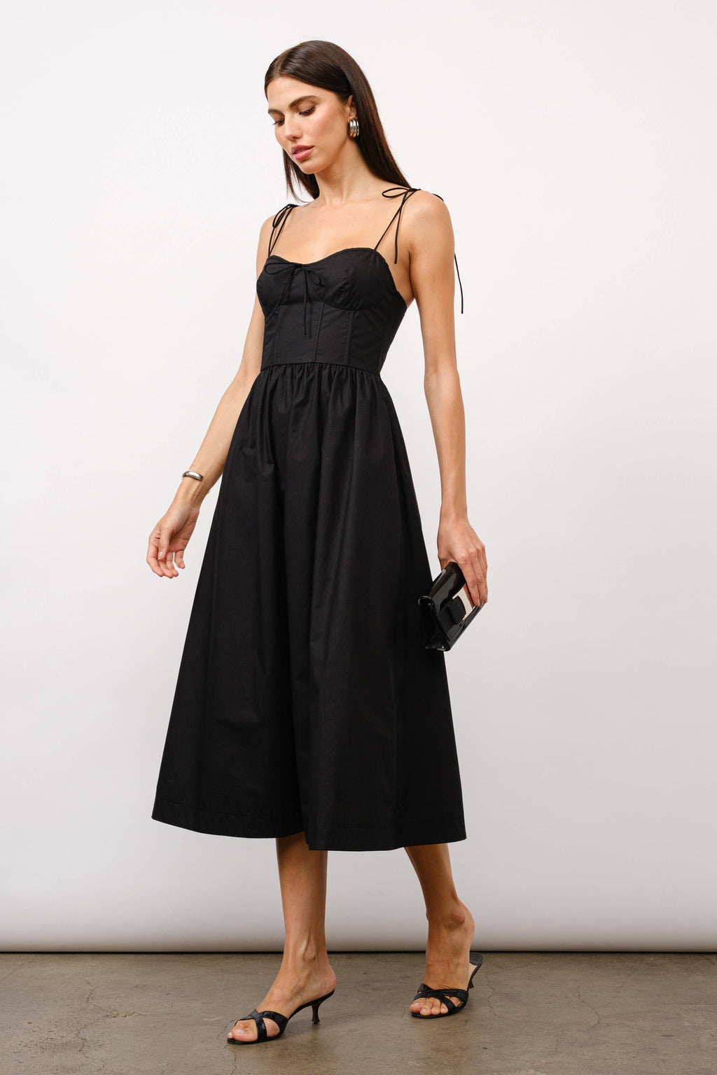 Black midi dress, corset midi dress, tie-strap dress, sweetheart neckline dress, black dress for date night, cocktail party dress, summer wedding outfit, corset dress with boning, elegant black dress, versatile midi dress, dress with pockets, fashion boutique dress.